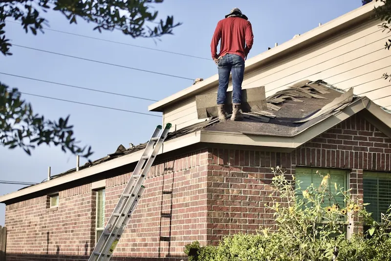 Professional roofer working on a residential roof in Tarpey Village
